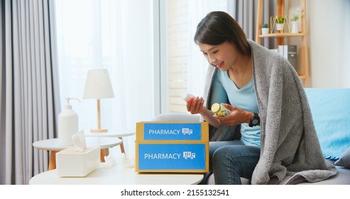 Asian Female Patient Wear Mask Covering Blanket Unpacked Medicine From Pharmacy Medication Package Box Delivery Service At Home