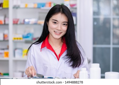 asian female pharmacist  clouting medication for packages in pharmacy Thailand sport focusing - Shutterstock ID 1494888278
