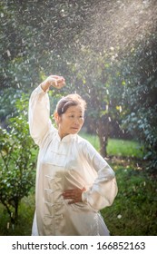 Asian Female Practice Taichi In The Park