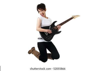 Asian Female Rockstar Holding Guitar Jumping In Air.