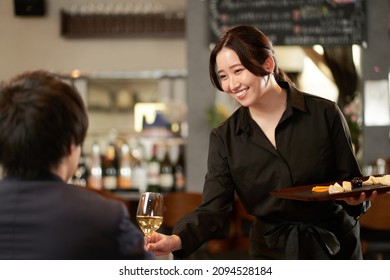 Asian female servicing at a restaurant - Powered by Shutterstock