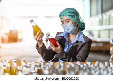 Asian Female Specialist Worker Wearing Hairnet And Protective Mask Working And Checking Goods Or Product Of Basil Seed With Fruit On Shelf Pallet At Beverage Factory. Food, Beverage Industry Concept