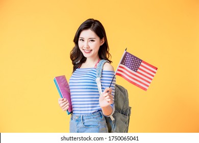 Asian Female Student Smile And Look To You With USA Flag Isolated Yellow Background