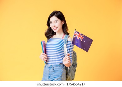 Asian Female Student Smile And Look To You With Australian Flag Isolated Yellow Background