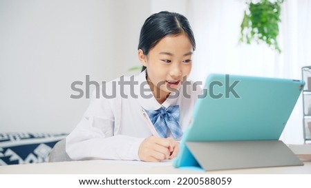Asian female student studying with a tablet PC. Online class. e-learning.