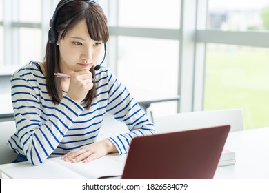 Asian female student taking online class. e-learning. Remote work. - Shutterstock ID 1826584079