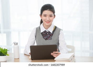 Asian female students taking classes on the Internet
 - Shutterstock ID 1682207989