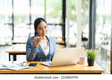 Asian Female Talking About Sale Report In Video Conference. Asian Team Using Laptop And Tablet Online Meeting In Video Call.Working From Home Remotely.