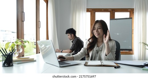 Asian Female Talking About Sale Report In Video Conference. Asian Team Using Laptop And Tablet Online Meeting In Video Call.Working From Home Remotely.
