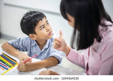 Asian Female Teacher Teaching Kid Writing Stock Photo 1694364517 ...