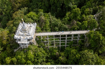 Asian female tourist in yellow dress and hat at The large ancient pagoda arch is beautiful, Khao Na Nai Luang Dharma Park, Surat Thani, Thailand. - Powered by Shutterstock