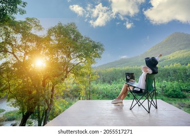 Asian Female Tourists Wake Up Early To See The Rising Sun. Travel She Likes To Travel In Style. Beautiful Nature Forests And Mountains Work Happy Holidays With Freelance Work On Laptop