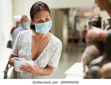 Asian Female Visitor With Mask At Exhibition In Museum