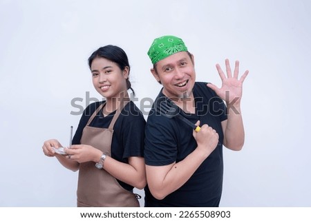 An asian female waitress and male cook. Friendly restaurant staff isolated on a white background. Full-service restaurant industry.