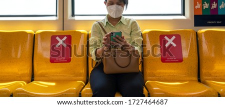 Asian female woman sitting in subway distance for one seat from other people a social distancing for protect coronavirus or covid-19 virus a new normal trend. Social distancing or new normal concepts
