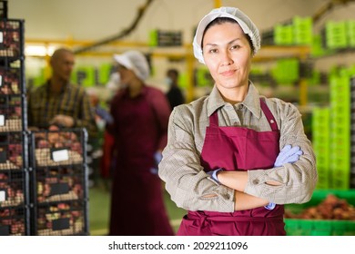 Asian female worker at the fruit warehouse