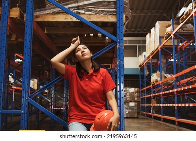 Asian Female Workers Sit And Take Off Their Safety Hats Tired Of The Warehouse Work Many Check Stocks Are Overworked Tired And Exhausted Sit And Take Break To Wipe The Sweat On Their Faces.
