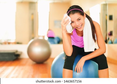 Asian Fitness Girl Training At Gym Wiping Sweat With Towel Post Workout Happy At Gym. Exercise And Healthy Living Weight Loss Concept.