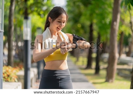 asian Fitness woman setting up smart watch before running training during morning workout,female checking heartrate and pulse from smart watch monitor after running fininsh healthy lifestyle concept