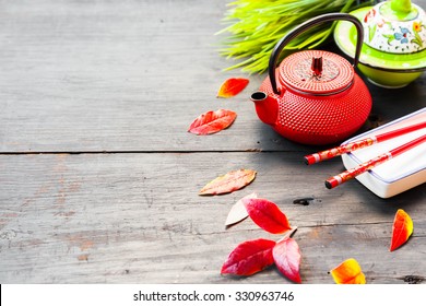 Asian Food Concept, Tea Pot, Herbs And Chopsticks On Old Wooden Table