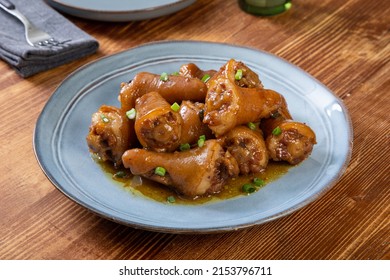 Asian Food Cooked Pork Tails On Rustic Kitchen Table