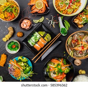 Asian food served on black stone, top view. Chinese and vietnamese cuisine set. - Shutterstock ID 585396362
