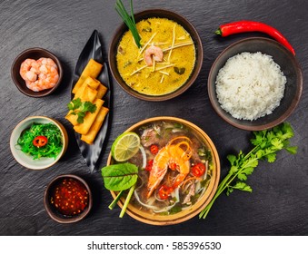 Asian food served on black stone, top view. Chinese and vietnamese cuisine set.