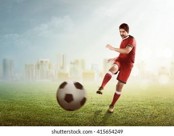 Asian Football Player Kick Ball On The Stadium