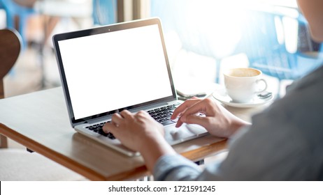 Asian Freelance Man Using Laptop Computer Working In The Cafe. Businessman In Casual Clothing Doing Online Conference Or Telecommuting. Remote Work From Anywhere. Blank Monitor Screen For Advertising.