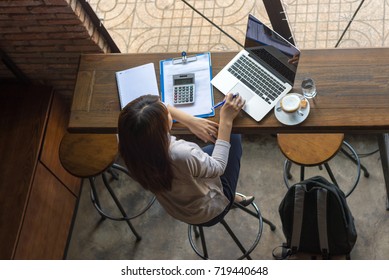 Asian Freelancer Working On Laptop At Cafe