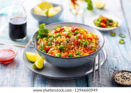 Asian fried rice. Blue wooden background. Close up.