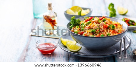 Asian fried rice, Cantonese cuisine.  Blue wooden background. Copy space. Close up.