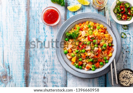 Asian fried rice, Cantonese cuisine.  Blue wooden background. Top view. Copy space.