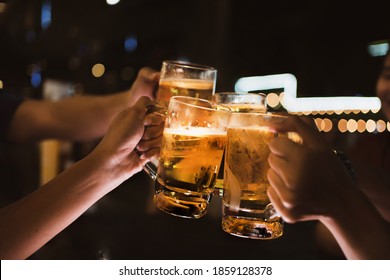 Asian Friends Drinking Beer Outdoors At The Brewery For The New Year Festival At Night Time