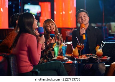 Asian Friends Enjoying Friendship Together In Karaoke Bar, Social Gathering Event And Nightlife Entertainment Concept, Friends Singing At Karaoke, Time To Sing, Having Good Time On The Weekend.