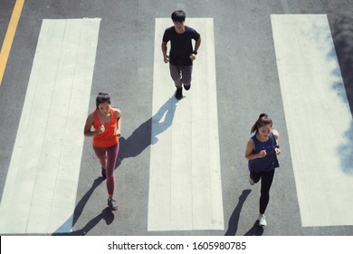 Asian Friends Group Running In The Morning. Top View.