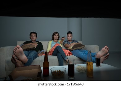 Asian Friends Watching Tv Show At Home