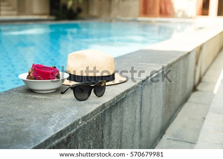 Asian fruits and women's accessories at pool