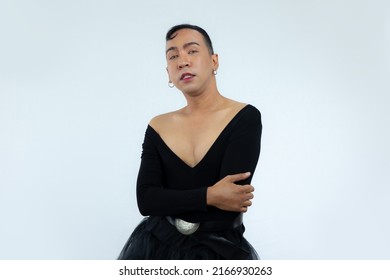 Asian Gay Man In Black Dress Posing On The White Screen Background.