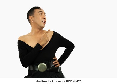 Asian Gay Man In Black Dress Posing Finger Pointing On The White Screen Background Lgbt Or Lgbtq Concept.