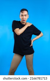 Asian Gay Man Look Feminine In Black T-shirt Posing On The Blue Screen Background.