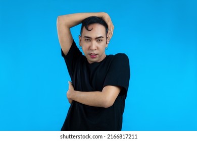 Asian Gay Man Look Feminine In Black T-shirt Posing On The Blue Screen Background.