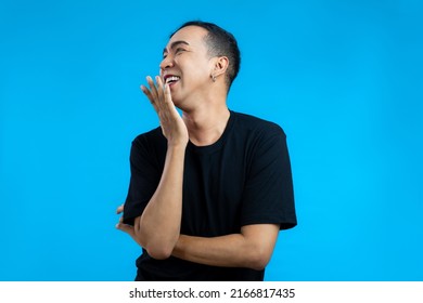 Asian Gay Man Look Feminine In Black T-shirt Posing On The Blue Screen Background.