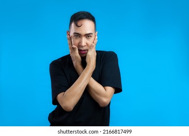 Asian Gay Man Look Feminine In Black T-shirt Posing On The Blue Screen Background.