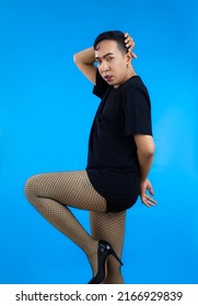 Asian Gay Man Look Feminine In Black T-shirt Posing On The Blue Screen Background.