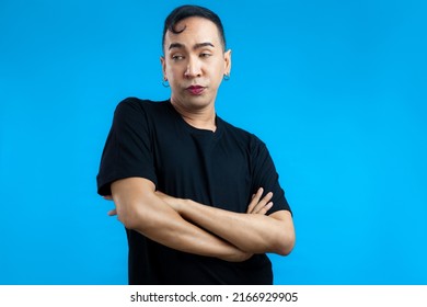 Asian Gay Man Look Feminine In Black T-shirt Posing On The Blue Screen Background.