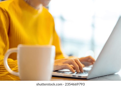 Asian Generation Z woman freelancer working business freelance job on laptop computer with using AI browsing data in coffee shop. Young woman working outside office on laptop with online network. - Powered by Shutterstock