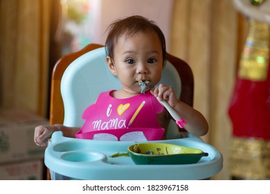 Asian Girl 11 Months Year Old Is Eating Food On Baby Table Food.