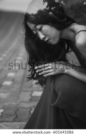 Similar – beautiful brunette short hair girl leaning on gray rock wall outdoors smiling happy