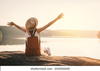 Asian girl backpack in nature during sunset , Relax time on holiday concept travel,selective and soft focus,color tone of hipster style